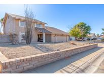 Two-story house with a landscaped yard and two-car garage at 4129 W Hearn Rd, Phoenix, AZ 85053