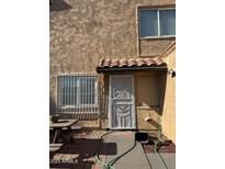 Exterior view of a condo with a security door and small patio area at 4714 E Broadway Rd, Phoenix, AZ 85040