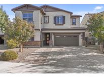 Charming two-story home with a brick paved driveway and neutral colored stucco at 55 N Abalone Ct, Gilbert, AZ 85233