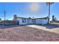 Ranch style home with a large front yard and driveway at 6649 W Orange Dr, Glendale, AZ 85301