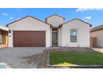 One-story home with brown garage door and landscaped lawn at 699 E Greenback Dr, San Tan Valley, AZ 85140