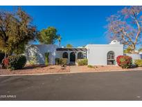 White stucco house with arched entryway and landscaped front yard at 8018 N 3Rd Pl, Phoenix, AZ 85020