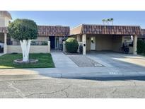 Attractive single-story home with carport and well-manicured landscaping at 9746 N 105Th Dr, Sun City, AZ 85351