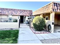 Landscaped front yard with walkway leading to the entrance at 9746 N 105Th Dr, Sun City, AZ 85351