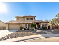 Two-story house with tile roof, landscaping, and a large driveway at 14422 S 24Th Pl, Phoenix, AZ 85048