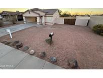 Single-story house with a small front yard and gravel landscaping at 16008 N Hollyhock St, Surprise, AZ 85378