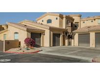 Spanish-style condo building with attached garages and desert landscaping at 16410 S 12Th St # 206, Phoenix, AZ 85048