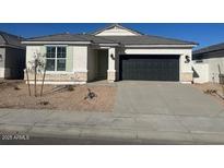 One-story home with a two-car garage and desert landscaping at 17814 W Carol Ave, Waddell, AZ 85355