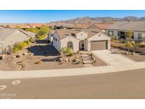 Single-story home with desert landscaping and a two-car garage at 18873 N 262Nd Dr, Buckeye, AZ 85396