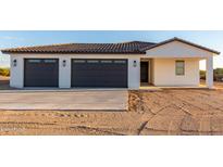 New home exterior boasts a two-car garage and desert landscaping at 23437 E Cactus Forest Rd, Florence, AZ 85132