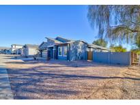 Single-story home with gray exterior, two-car garage, and desert landscaping at 2508 N Franz Ln, Casa Grande, AZ 85122