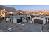 Beautiful desert home featuring a neutral color palette, paver driveway, and mountain views at 4215 S Willow Springs Trl, Gold Canyon, AZ 85118