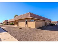 Tan stucco building with a tile roof and small landscaped area at 501 W Yukon Dr # 8, Phoenix, AZ 85027