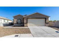 Newly built home with a neutral color scheme and a two-car garage at 603 S 7Th St, Avondale, AZ 85323