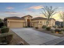 Single-story home with a three-car garage and desert landscaping at 8531 E Twisted Leaf Dr, Gold Canyon, AZ 85118