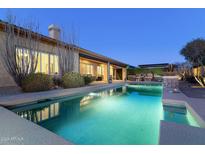 Relaxing rectangular pool in the backyard at dusk at 8531 E Twisted Leaf Dr, Gold Canyon, AZ 85118