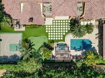 Bird's eye view of the home, highlighting the pool and sport court at 11571 E Cochise Dr, Scottsdale, AZ 85259