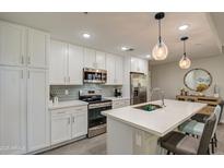Modern kitchen with white cabinets, stainless steel appliances, and a large island at 155 N Lakeview Blvd # 118, Chandler, AZ 85225
