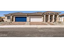 Charming single-story home featuring a brick driveway, three-car garage, and stucco exterior, perfect for comfortable living at 24914 N 173Rd Ln, Surprise, AZ 85387