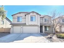 Two-story home with three-car garage and desert landscaping at 43439 W Magnolia Rd, Maricopa, AZ 85138