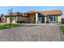 Beautiful home with a paver driveway and landscaped front yard at 5660 N 78Th Ave, Glendale, AZ 85303