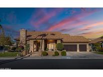 Beautiful two-story home with stone accents and a three-car garage at 6302 E Monte Cristo Ave, Scottsdale, AZ 85254