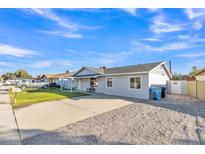 Newly renovated single-story home with a well-manicured lawn and driveway at 7607 N 42Nd Ln, Phoenix, AZ 85051