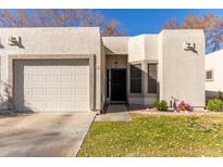 Well-maintained home with a two-car garage and landscaped front yard at 9270 W Morrow Dr, Peoria, AZ 85382