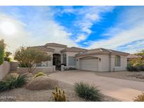 Beautiful desert landscape surrounds this single-story home with a three-car garage at 11003 E Turnberry Rd, Scottsdale, AZ 85255