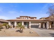 Two-story house with a three-car garage and desert landscaping at 15450 W Tasha Cir, Surprise, AZ 85374