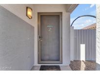 Inviting front door entrance with screen door and welcome mat at 15854 W Gelding Dr, Surprise, AZ 85379