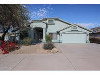 House exterior featuring a two-car garage and well-manicured landscaping at 16796 W Pierce St, Goodyear, AZ 85338