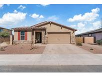 Charming single-story home with a tile roof, stone accents, and a two-car garage at 18188 W Fulton St, Goodyear, AZ 85338