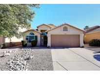 House exterior features a two-car garage and a rock garden at 20031 N 22Nd Pl, Phoenix, AZ 85024