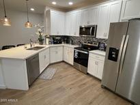 Modern kitchen featuring white cabinets, stainless steel appliances, and a large island at 2511 W Queen Creek Rd # 377, Chandler, AZ 85248