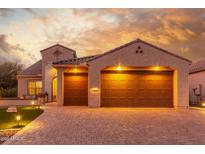 Two-car garage, attractive landscaping, and brick paver driveway at 2562 N 169Th Ave, Goodyear, AZ 85395