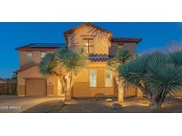 Two-story house with a landscaped yard and a three-car garage at dusk at 3730 E Kingbird Pl, Chandler, AZ 85286