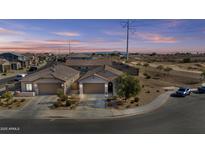 Aerial view of two story house, landscaped yard, and neighborhood at 5013 S 112Th Ave, Tolleson, AZ 85353