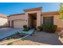 Single-story home with two-car garage and desert landscaping at 6334 E Viewmont Dr # 9, Mesa, AZ 85215