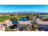 Aerial view of luxury townhome community near golf course and mountains at 8989 N Gainey Center Dr # 222, Scottsdale, AZ 85258