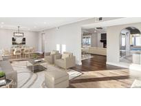 Spacious living area with hardwood floors, plush seating, and views to dining area at 9412 N 33Rd Way, Phoenix, AZ 85028