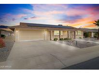 House exterior with solar panels and landscaped yard at 10537 W Prairie Hills Cir, Sun City, AZ 85351