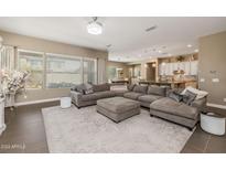 Large living room with sectional sofa and big windows at 10550 E Sanger Ave, Mesa, AZ 85212