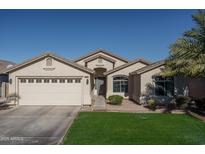 Single-story house with a two-car garage and well-maintained lawn at 11246 W Chase Dr, Avondale, AZ 85323