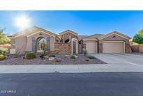 Single-story home with stone accents and a three-car garage at 1211 W Sousa Ct, Anthem, AZ 85086