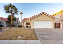 House exterior featuring a two-car garage and desert landscaping at 1326 W Seascape Dr, Gilbert, AZ 85233