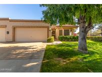 Single story home with attached garage and landscaped lawn at 18881 N 91St Dr, Peoria, AZ 85382