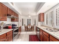 Well-equipped kitchen with wooden cabinets and stainless steel appliances at 18881 N 91St Dr, Peoria, AZ 85382