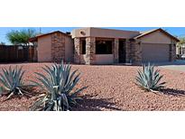 Attractive single-story home with stone accents and a well-maintained front yard at 19624 N 16Th Dr, Phoenix, AZ 85027