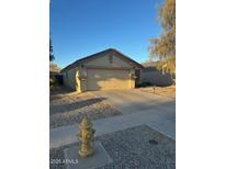 Single-story house with a two-car garage and desert landscaping at 2172 W Pinkley Ave, Coolidge, AZ 85128